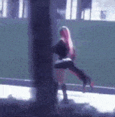 a woman with pink hair is holding a man in her arms