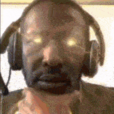 a close up of a man wearing headphones and a microphone .