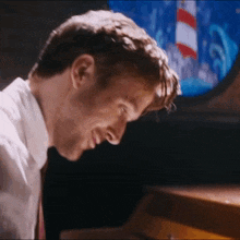 a close up of a man playing a piano