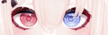 a close up of a girl with red and blue eyes .