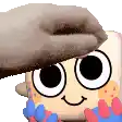 a person is putting a hat on a cartoon character with big eyes .