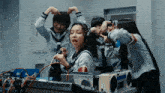 a girl wearing headphones holds a microphone in front of a mixer