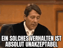a man in a judge 's robe is sitting in a courtroom with a caption .