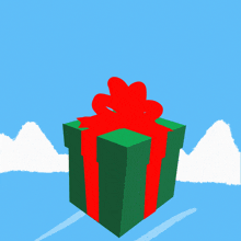 a woman in a santa outfit is jumping out of a christmas present