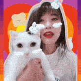 a woman is holding a white cat with a bunny on her head