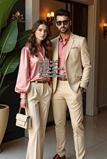 a man and a woman are standing next to each other and the woman is wearing a pink shirt and the man is wearing tan pants