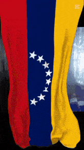 a red yellow and blue flag with a circle of stars