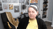 a woman wearing a headband and a yellow shirt that says " be a girl "