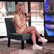 a woman is sitting in a chair with her legs crossed