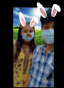 a boy and a girl wearing masks with bunny ears on them