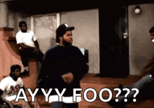 ice cube is standing in front of a group of men and says ayy foo