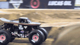 a monster truck that looks like a skateboard is driving down a dirt track