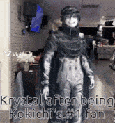 a person is standing in a hallway with the words `` krystal after being kokichi 's # 1 fan '' written on it