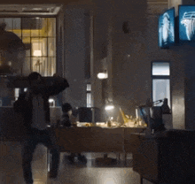 a man is dancing in a room with a sign that says daily mail on it