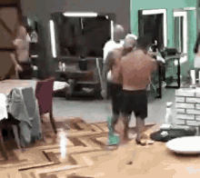 a group of men are standing next to each other in a living room .
