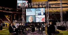 a group of musicians are playing in front of a large screen that says pixels society