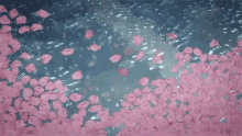 a bunch of pink petals are falling into the water