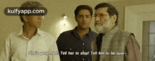 three men are standing next to each other in a room and one of them is talking to the other .