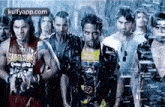 a group of people are standing next to each other in a line .