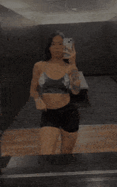 a woman taking a selfie in a locker room