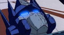 a close up of a cartoon robot with blue eyes