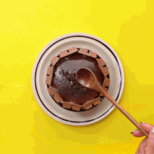 a person 's hand is reaching for a piece of cake