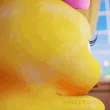 a close up of a rubber duck with a pink bow on its head .