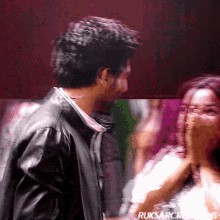 a blurry photo of a man and a woman with ruksarcreations written on the bottom right