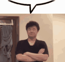 a man is standing with his arms crossed and a speech bubble above him