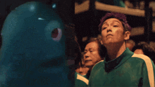 a man with purple hair is standing in front of a crowd