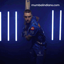 a man holding a cricket bat with the website mumbaiindians.com in the lower right corner