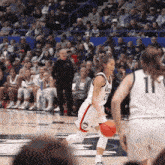 a ucsd basketball player dribbles a basketball on the court