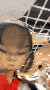 a close up of a child 's face with a blurred background