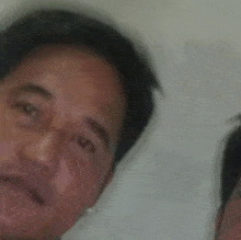 a man with a hu sticker on his forehead