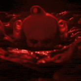 a creepy clown is surrounded by bloody hands