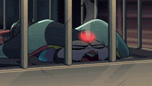 a cartoon character is laying in a jail cell