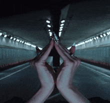 a woman with long nails is making a triangle with her hands