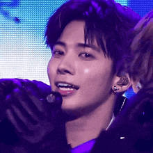 a close up of a person 's face with a microphone in his ear
