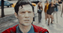 a man in a superman costume with a red cape