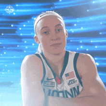 a female basketball player wearing a jersey with the word big east on it