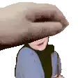 a hand is covering a person 's face with a hat .