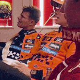 a man wearing an ibm shirt sits next to another man wearing an alwyn shirt