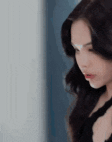 a close up of a woman 's face in a black dress