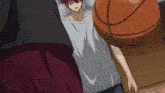 a man with red hair is holding a basketball in his hands