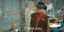 a man wearing a cowboy hat and a bandana says thank you