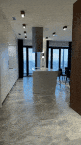 an empty kitchen with a large island in the middle