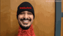 a man wearing a beanie with webchnl written on it