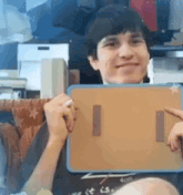 a man is holding a cardboard box that says 4cm