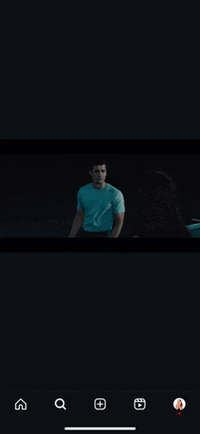 a man in a blue shirt is standing next to a woman in a car .