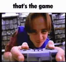 a young man is playing a video game with the words that 's the game below him